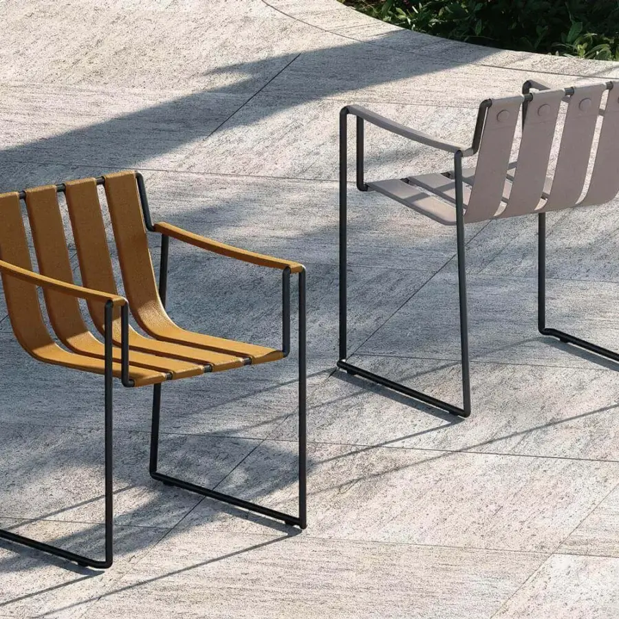 Elegant Royal Botania Strappy armchair with tan seat straps and dark finished coated stainless steel frame