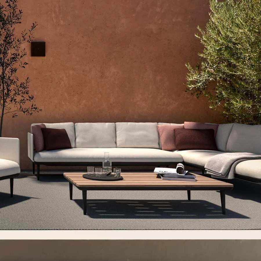 Lavish Royal Botania Styletto Lounge sectional with light gray fabric upholstery and dark metal stiletto legs with a teak wood coffee table