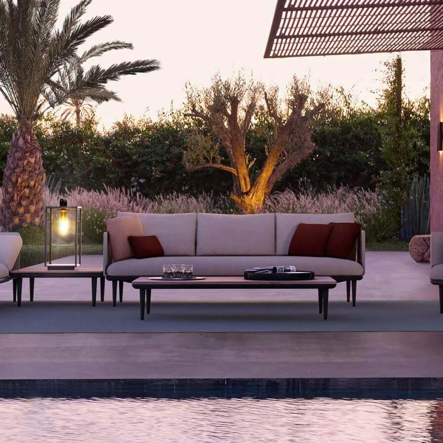 Exceptional Royal Botania Styletto lounge sofa with light beige or gray fabrics and reddish-brown pillows resting on a dark coated aluminum base