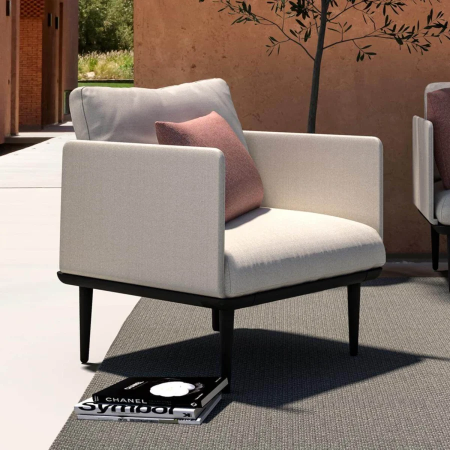 Sophisticated Royal Botania Styletto lounge chair with tapered coated aluminum legs and light beige fabrics with a pink cushion