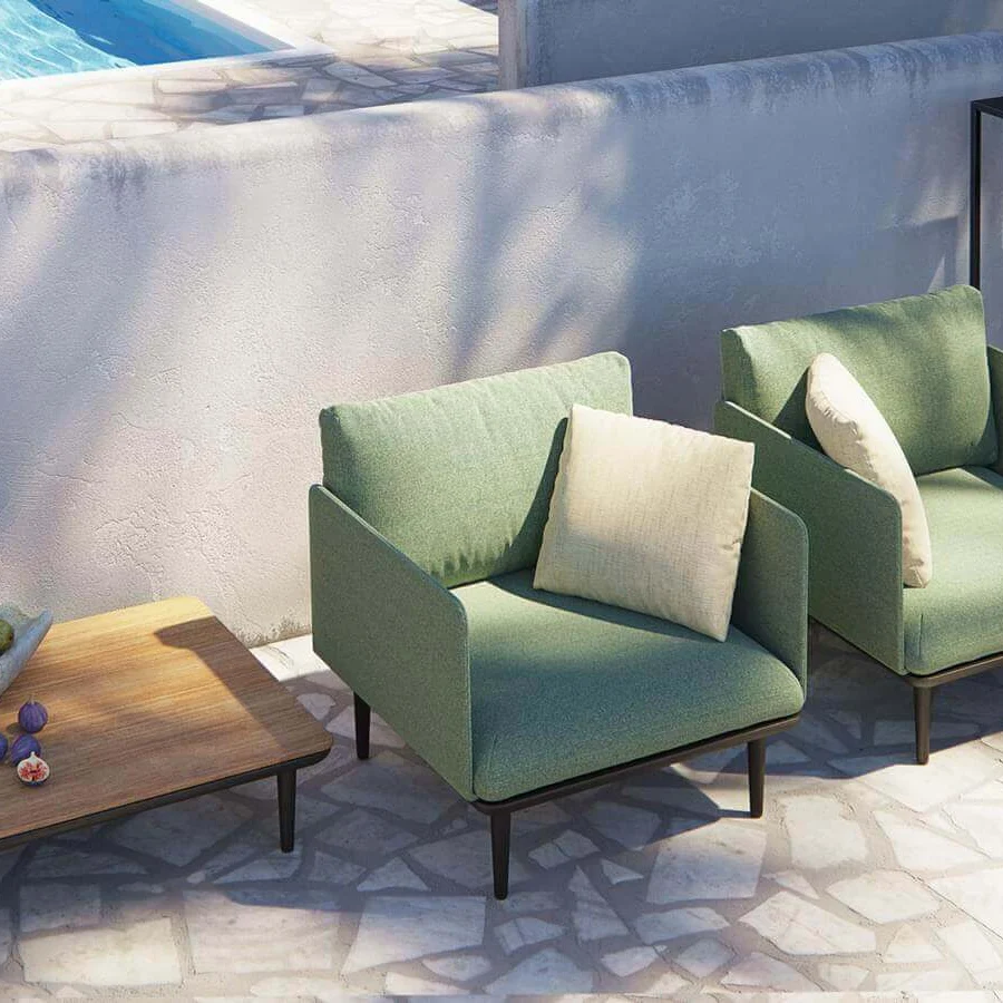 Elegant Royal Botania Styletto lounge chair in light green matte fabric with dark coated aluminum legs and beige cushion
