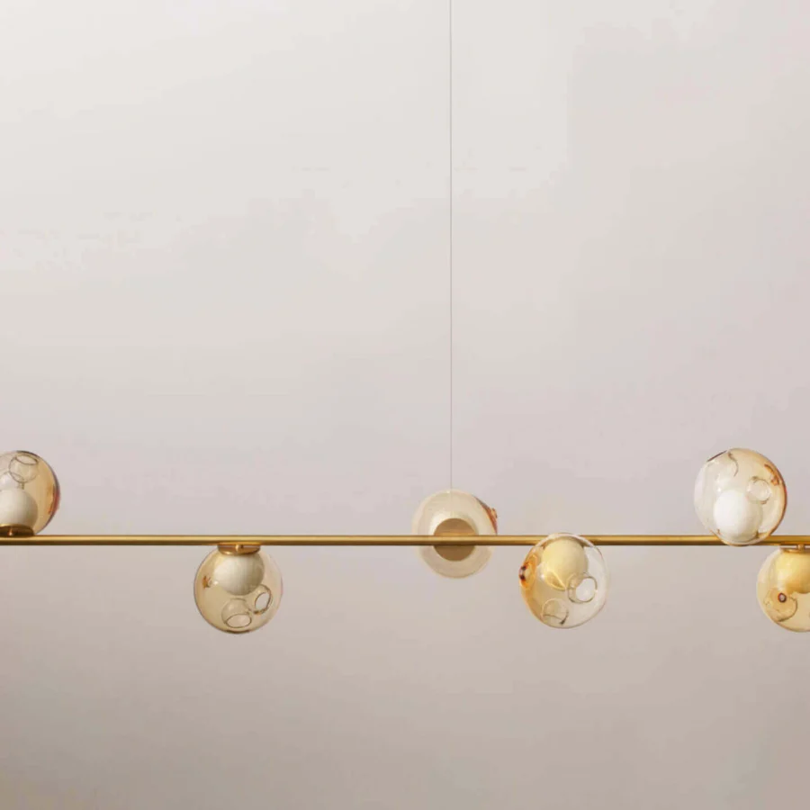 Superior Bocci 28 Stem suspension lamp with translucent warm amber hand-blown glass pendants and unlacquered brass structure