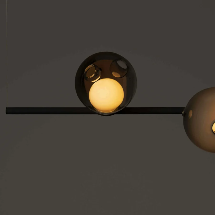 Distinguished Bocci 28 Stem suspension lamp with translucent amber glass spheres and a matte black unlacquered brass stem structure