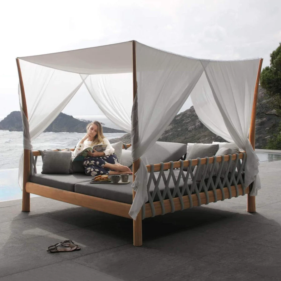 Distinguished Royal Botania Tuskany lounger with teak wood frame and woven olefin fiber side panels in warm brown and light gray textiles