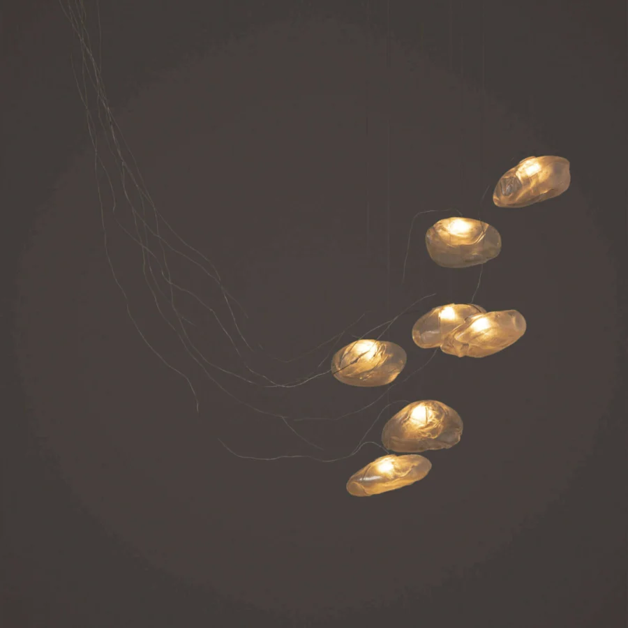 Refined Bocci 73 sculptural cable suspension lamp with seven organically shaped translucent glass shades and braided metal coaxial cable