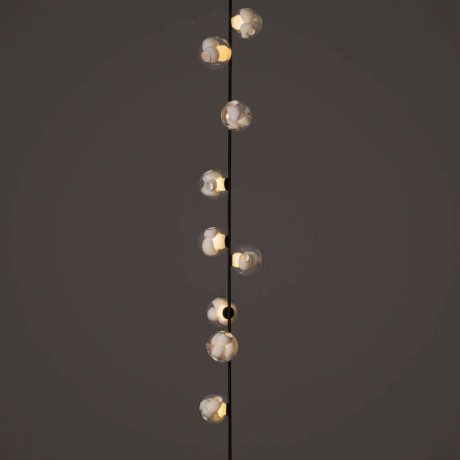 Elegant Bocci 38V Stem ceiling lamp with a slender black metal stem and clear glass shades containing milk white interiors
