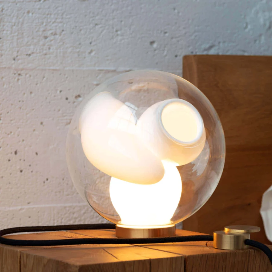 Captivating Bocci 38V Table Lamp with a clear glass exterior and milk white lamp holder cavities crafted in brass