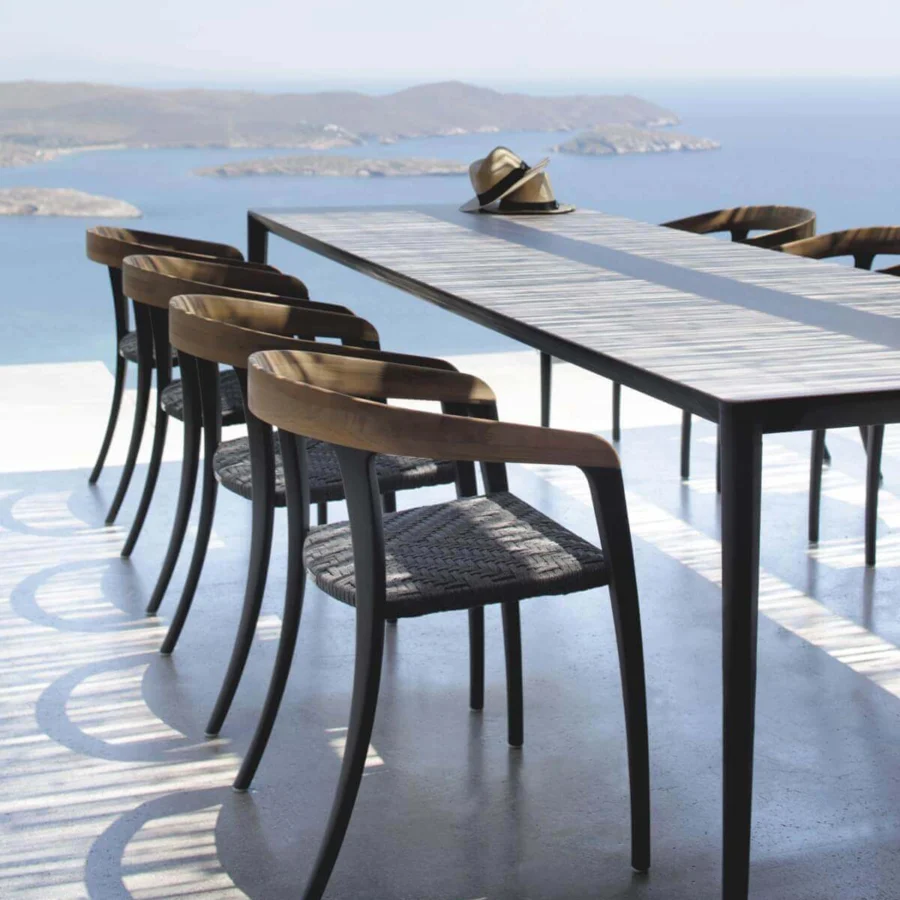 Harmonious Royal Botania Jive armchair built with tapered aluminum, teak, and a woven olefin seat offering a balanced aesthetic