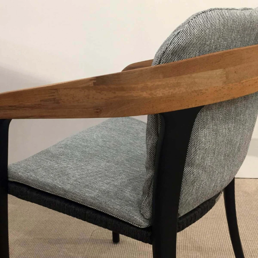 Sophisticated Royal Botania Jive armchair built with tapered aluminum, woven olefin, and light brown teak accents with a matte finish