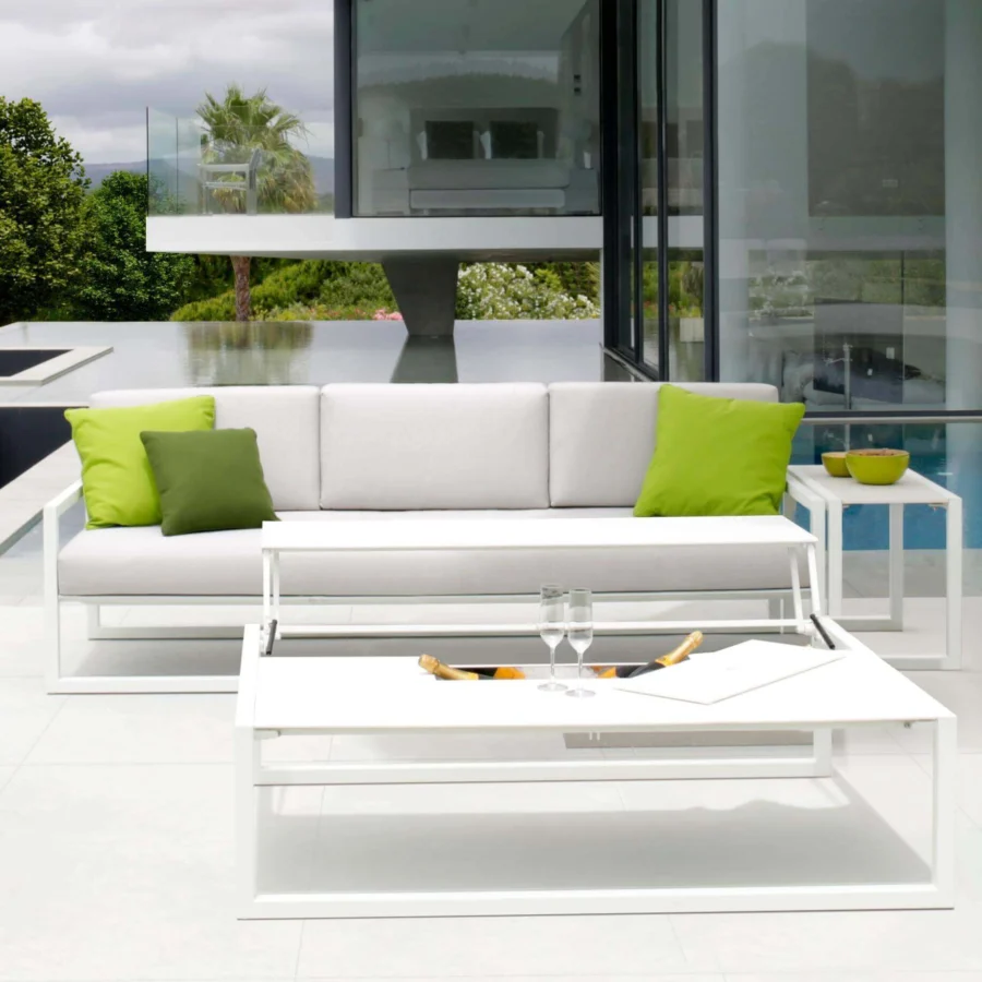Elegant Royal Botania Ninix lounge sofa with stainless steel frame and light grey Batyline seat complemented by vibrant green fabric cushions