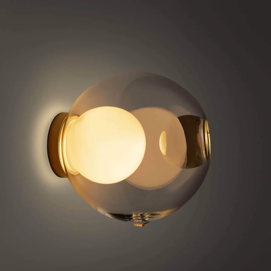 Superior Bocci 28s lamp crafted in clear glass with a milk white interior and polished brass mounting bracket
