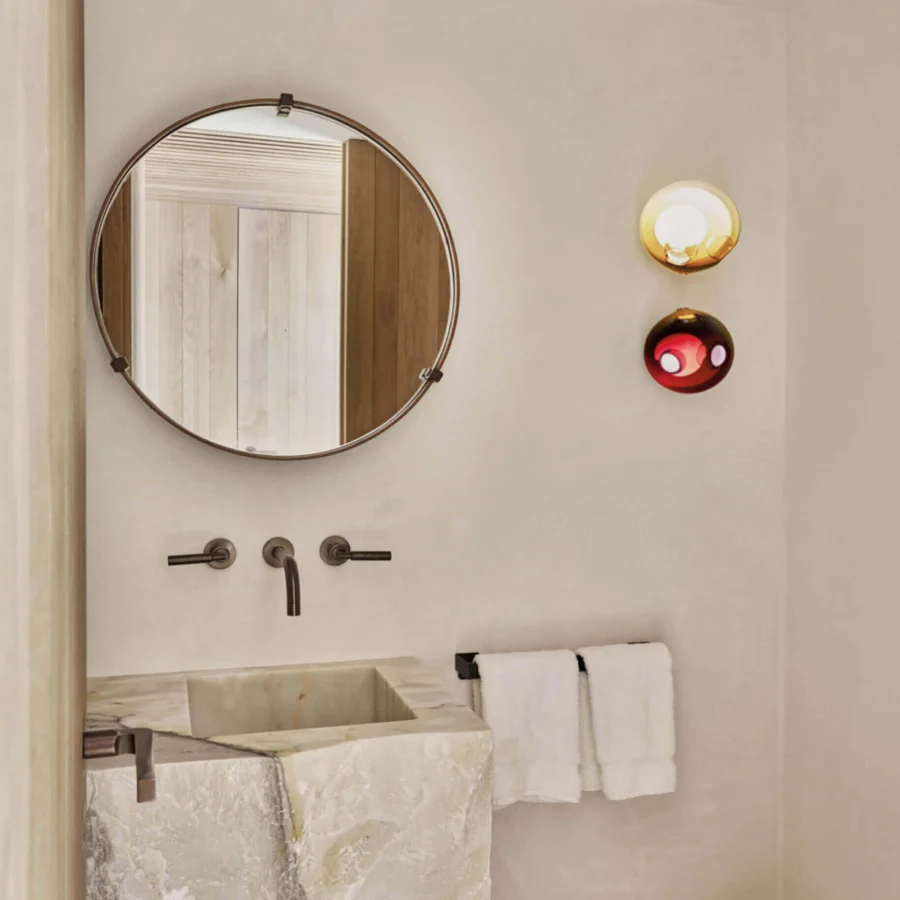 Elegant Bocci 28s lamp crafted with clear glass exterior and milk white interior, showcasing a gradient red to orange shade in a dark matte frame