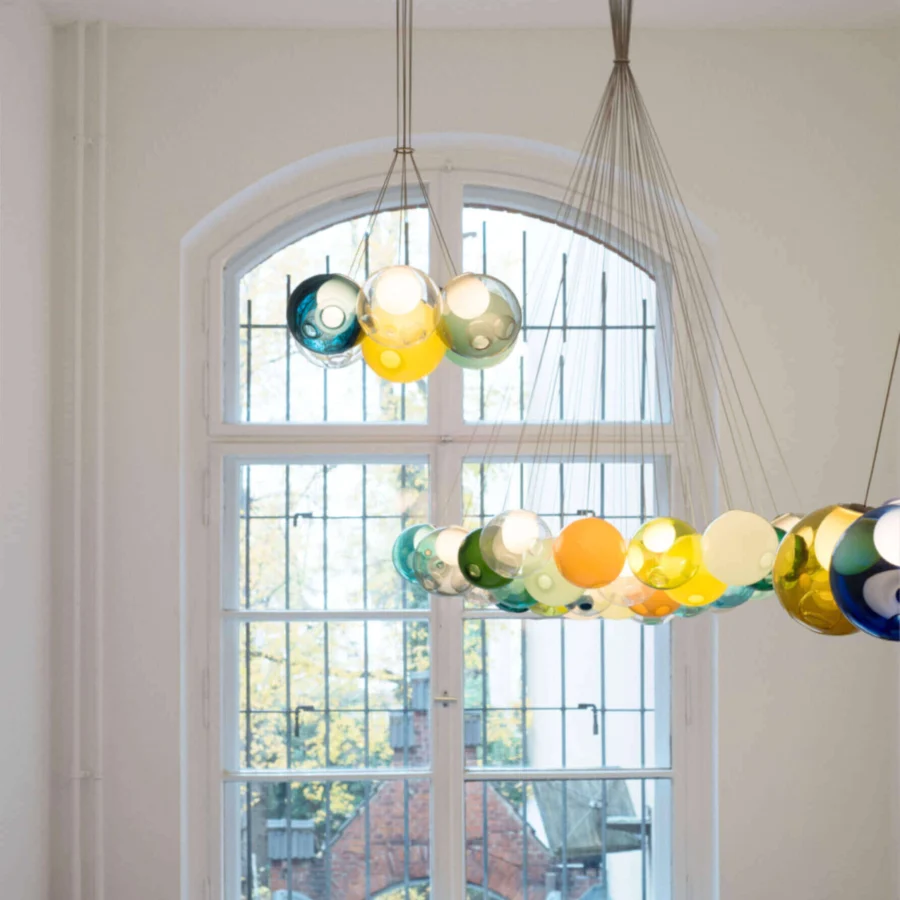 Exclusive Bocci 28 Cluster suspension lamp with a hexagonal bouquet of translucent hand-blown glass in yellow, green, blue and orange with polished metal support