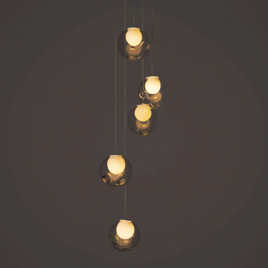Luxury Bocci 28 Random suspension lamp crafted with clear glass exhibiting a warm amber hue and milk white interior