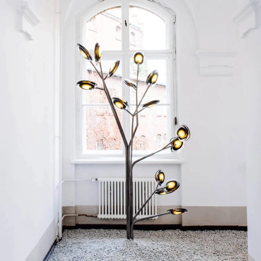 Exceptional Bocci 16 Tree floor lamp crafted with layered colored glass and smooth grey metal finish emitting a warm yellow glow