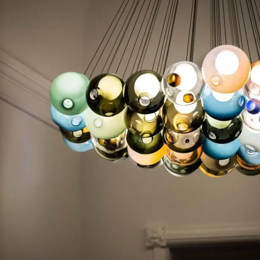 Superior Bocci 28 Cluster suspension lamp with dynamic interplay of blue, green, gold, and amber hues in clear glass holders