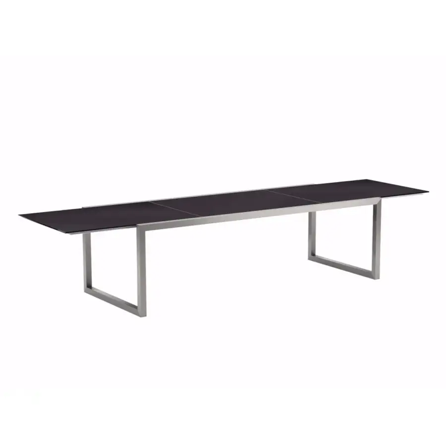 Distinguished Royal Botania Ninix extendable table with a dark segmented tabletop and brushed metal U-shaped legs built for longevity