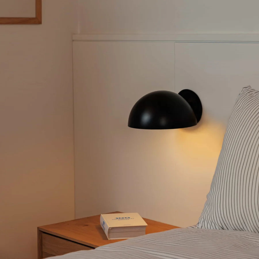 Wall-lamp by Faro Barcelona in steel with a matte black finish, constructed as a hemispherical shade and circular plate