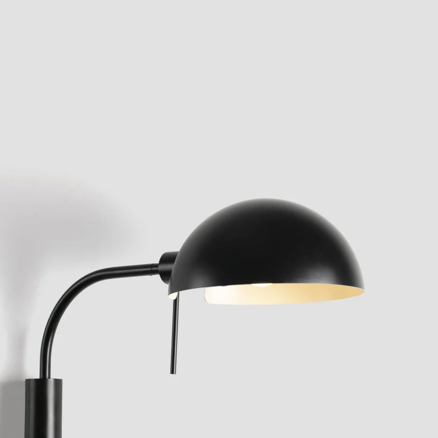Wall lamp by Faro Barcelona in steel with matte black finish, housing a cream interior shade and articulated arm
