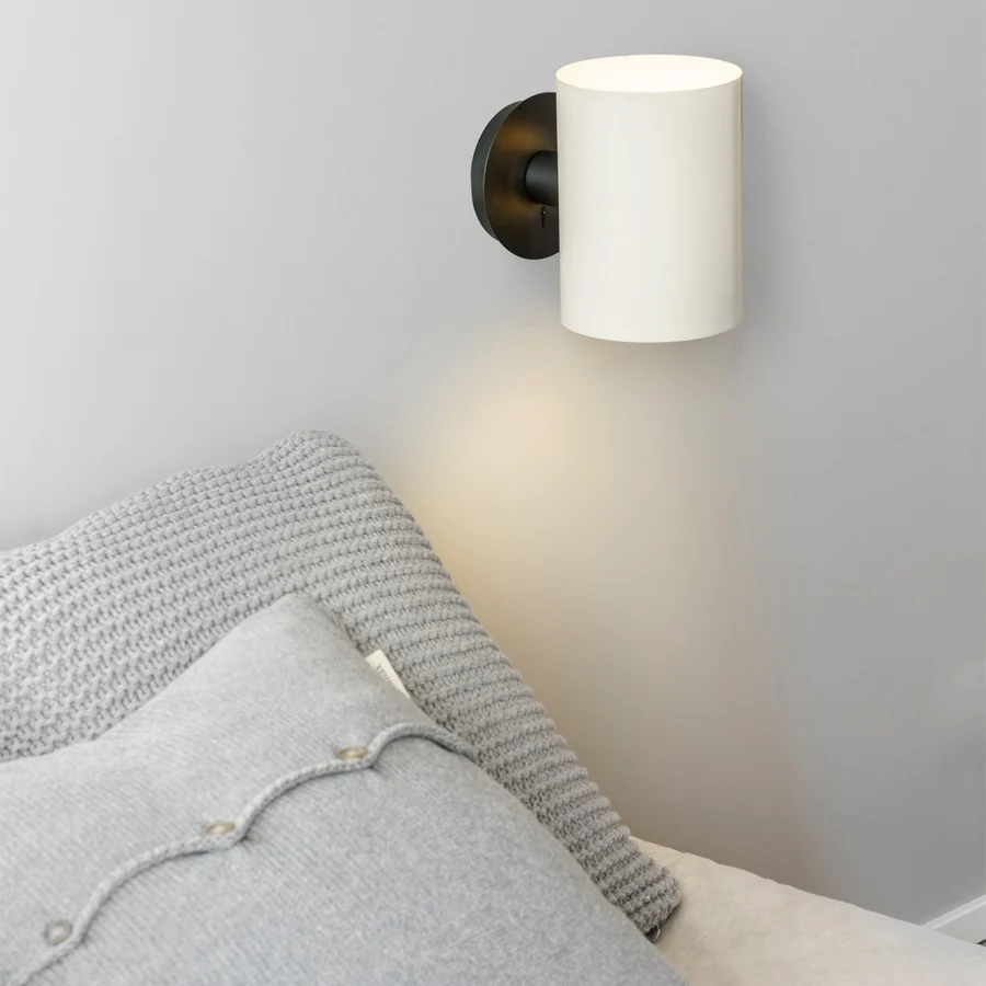 Wall lamp by Faro Barcelona with a cylindrical steel shade in beige and a matte black circular base and horizontal…