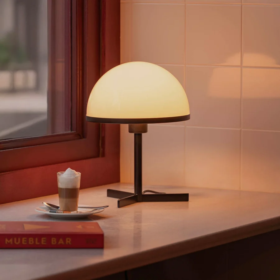 Table lamp by Faro Barcelona with frosted glass hemispherical shade and dark metal structure in a smooth matte finish