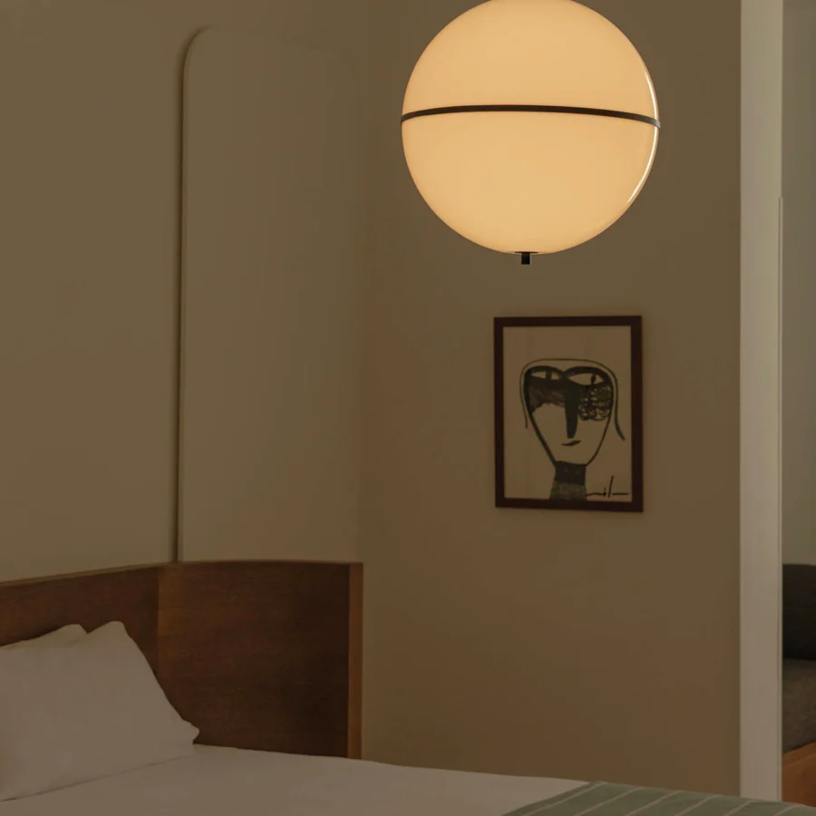 Suspension lamp by Faro Barcelona with spherical opaline diffuser and matte dark metal band on matching hanging cord