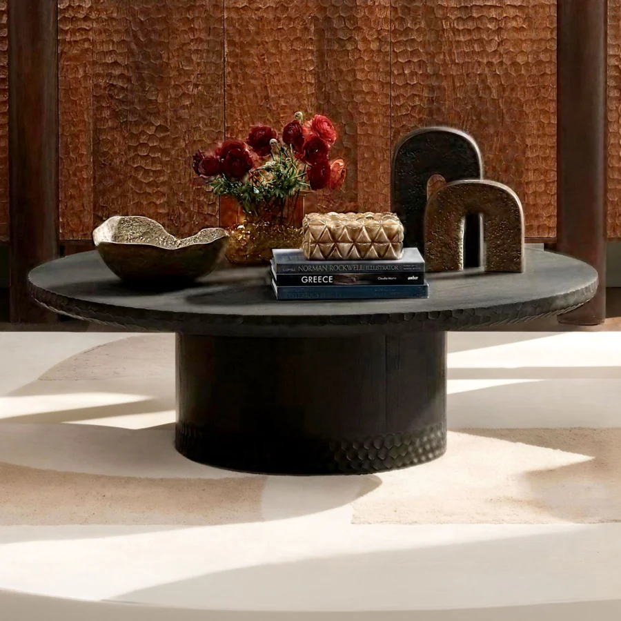 Coffee table by Dovetail Wilber in black mango wood with matte textured finish, circular pedestal base and scale carvings