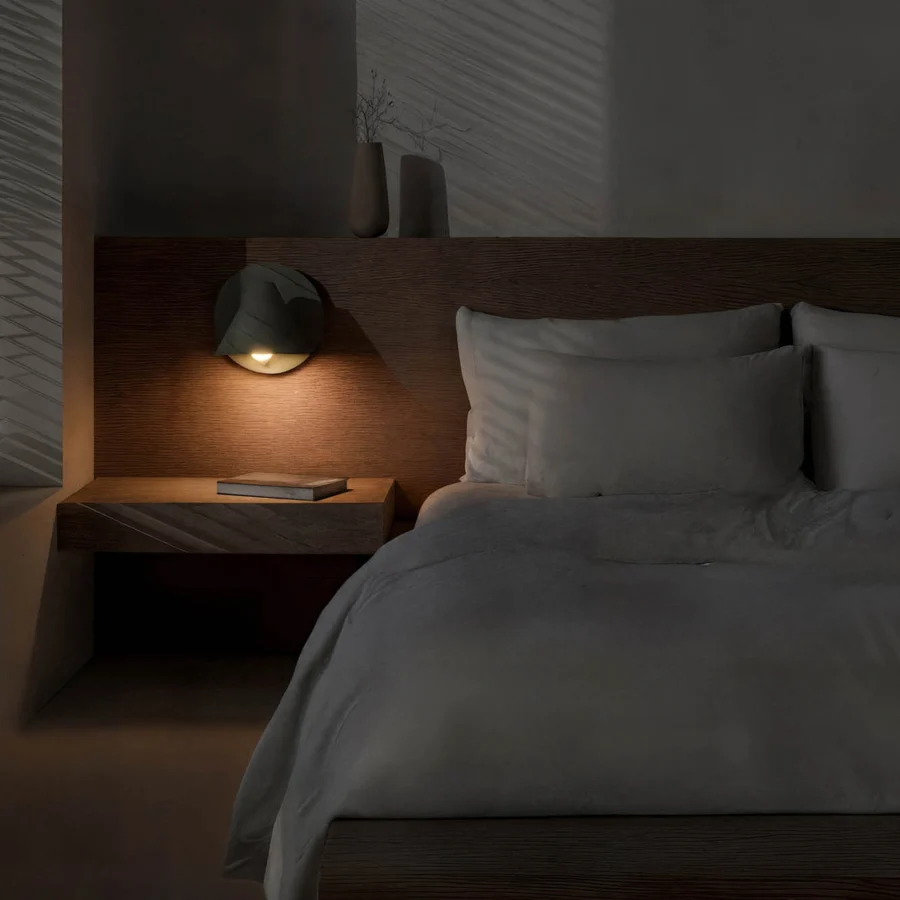 Wall lamp by Faro Barcelona in dark grey metal with matte finish and layered circular shade casting warm light