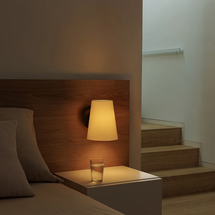 Wall-lamp by Faro Barcelona featuring a steel frame in black finish with a warm beige textile conical shade construction