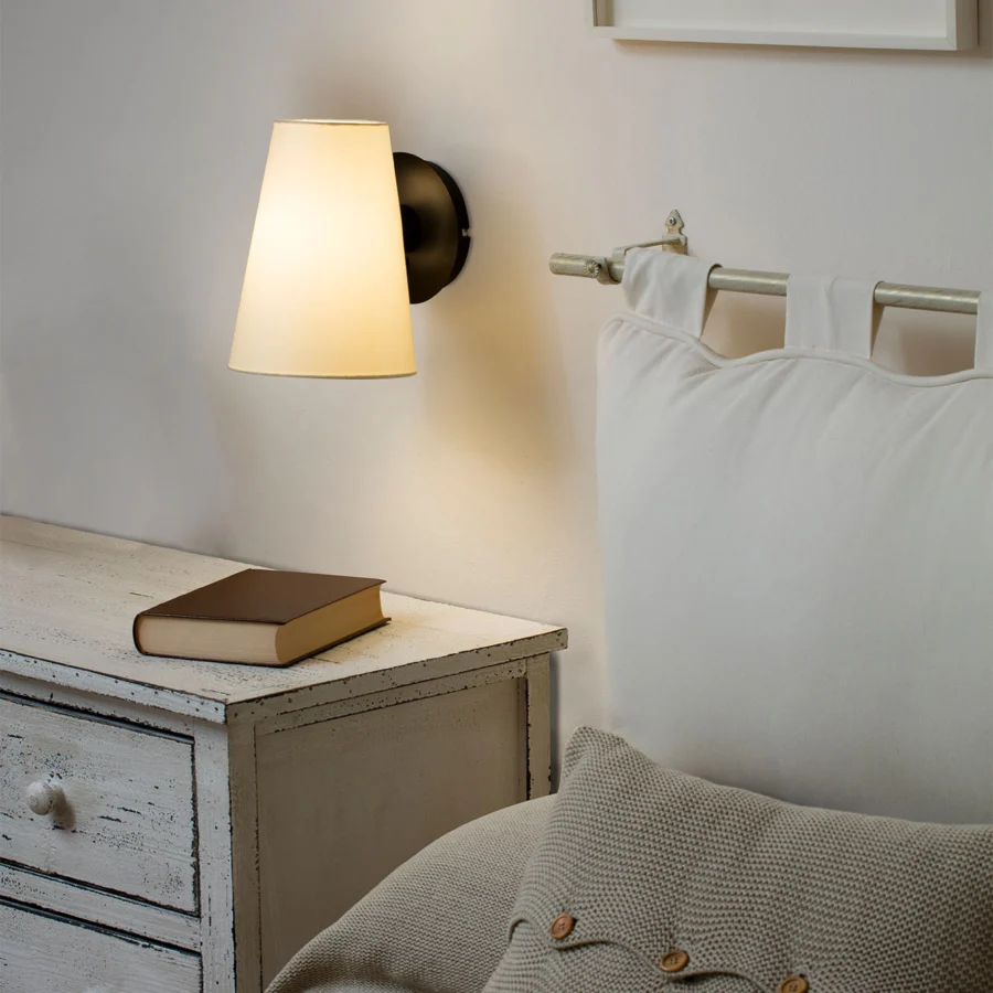 Wall lamp by Faro Barcelona with matte black steel base and tapered off-white textile shade in soft diffused light form