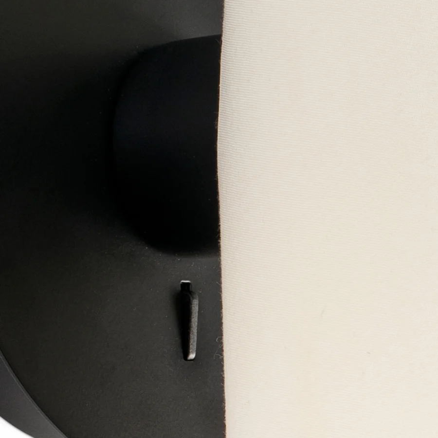 Wall lamp by Faro Barcelona in steel with matte black finish and off-white textile shade containing toggle switch