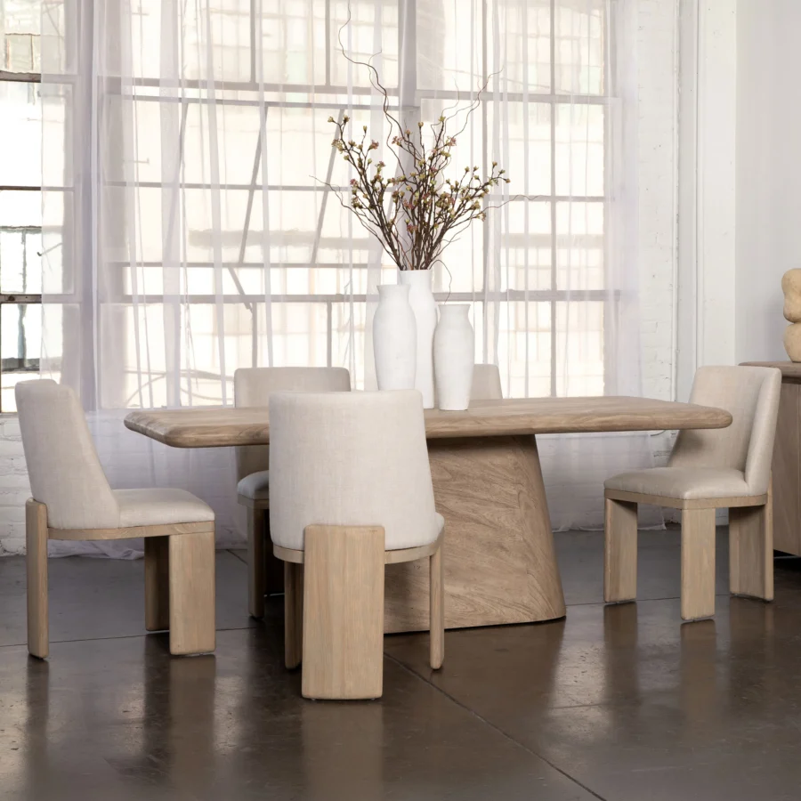 Dining table by Dovetail Marci in light beige solid acacia wood with weathered natural finish and wide pedestal base