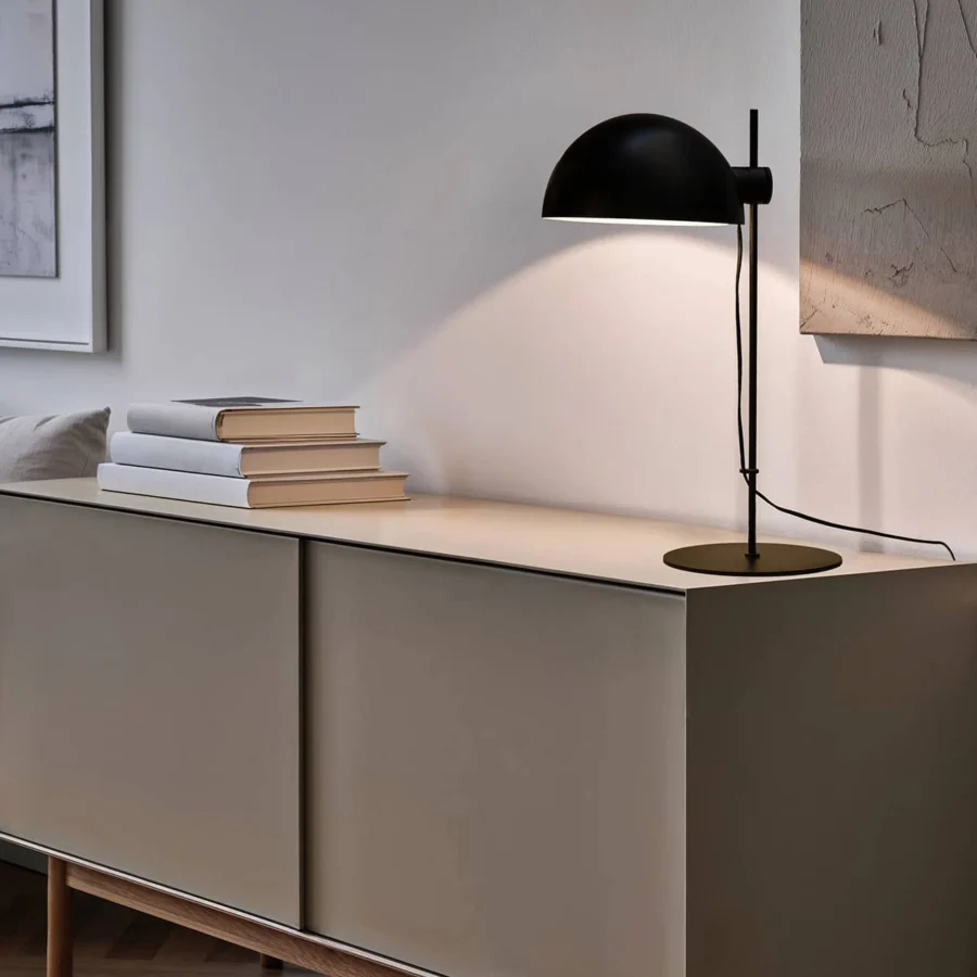 Table lamp by Faro Barcelona in steel, showcasing a matte black finish, flat circular base, and adjustable dome shade