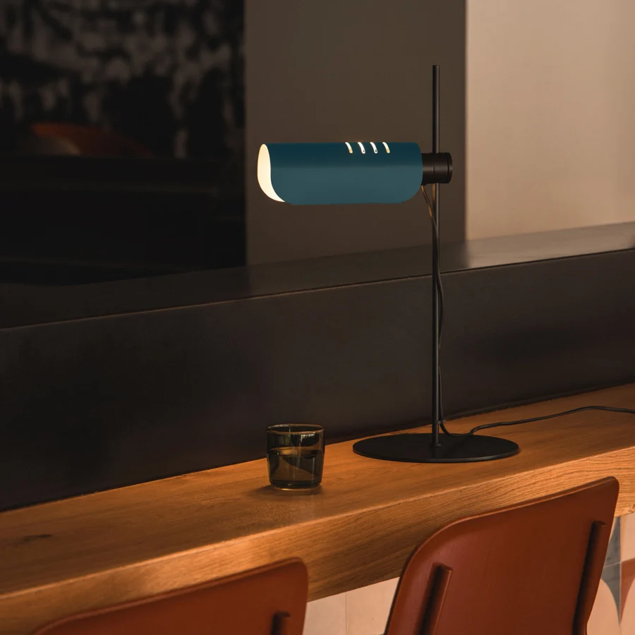 Lamp by Faro Barcelona in dark teal and matte black metal, featuring a thin stem, flat base, and cylindrical adjustable…