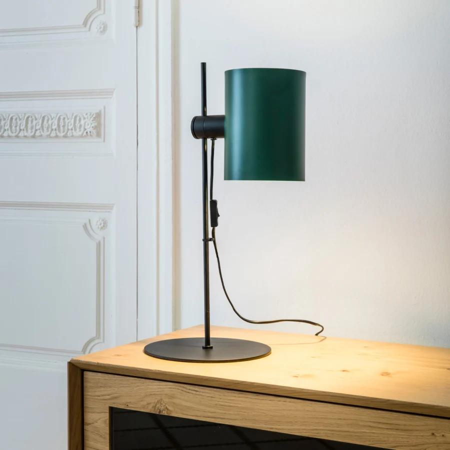 Table lamp by Faro Barcelona with a metal frame in matte black finish and dark green cylindrical shade for adjustment