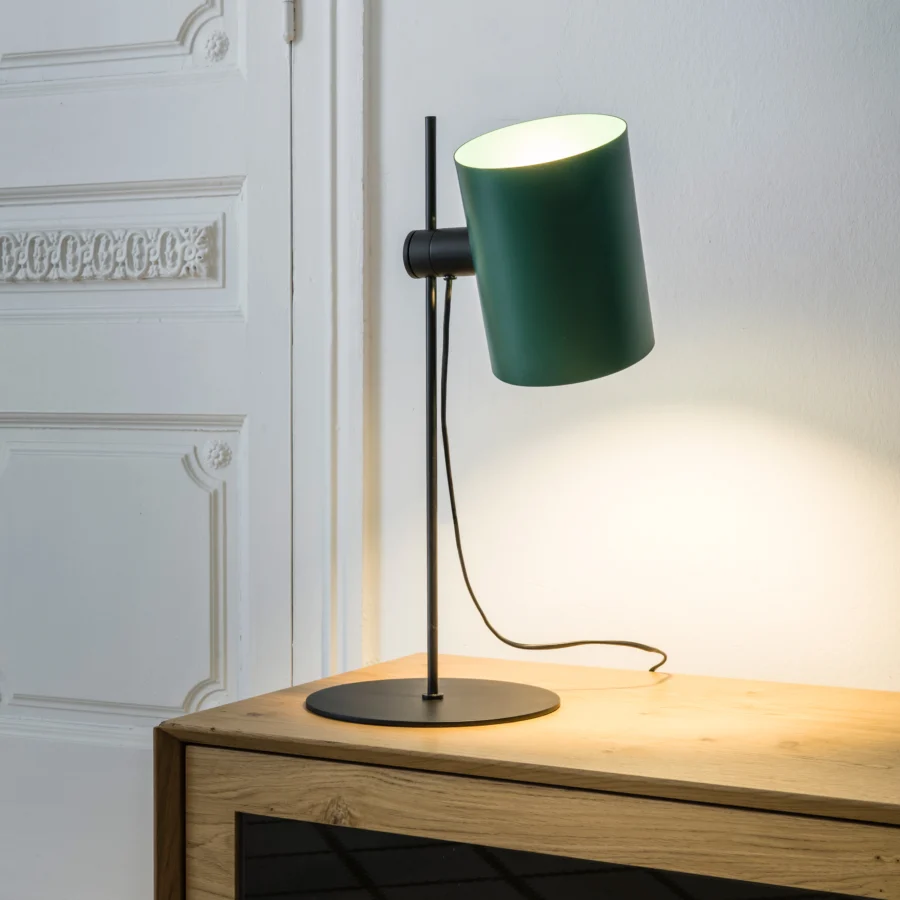 Table lamp by Faro Barcelona featuring metal construction, matte forest green cylindrical shade, black base, stem, and pivoting joint