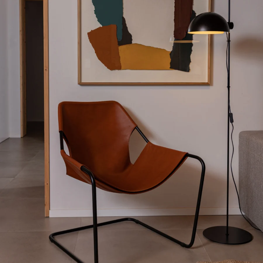 Floor lamp by Faro Barcelona in matte black metal with a slender stem and an adjustable hemispherical golden interior shade
