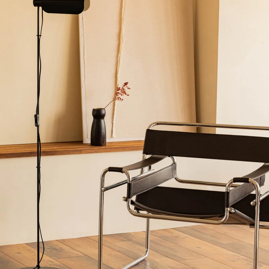 Lamp by Faro Barcelona in matte black metal with a slender vertical stem and a cylindrical perforated head