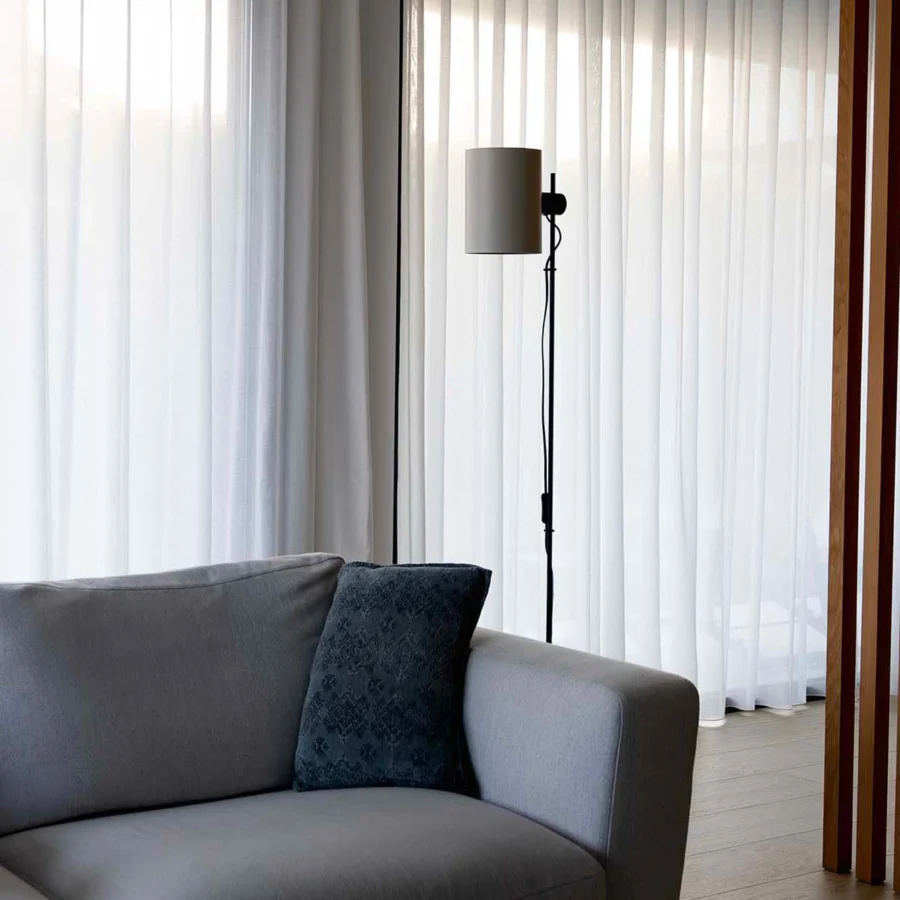 Floor lamp by Faro Barcelona with matte black metal stem and neutral fabric cylindrical shade plus directional points
