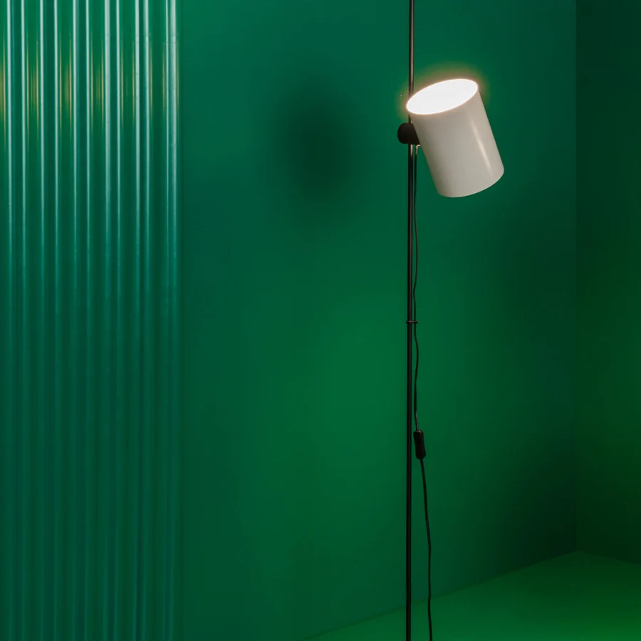 Floor lamp by Faro Barcelona with metal stem, flat circular base, and upright cylindrical shade in white and black finishes