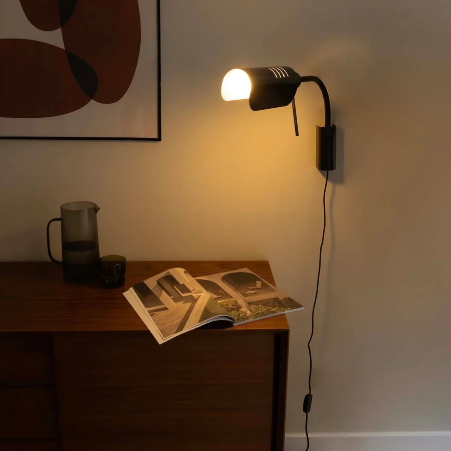 Wall lamp by Faro Barcelona in matte black metal with adjustable semi cylindrical head slender curved arm