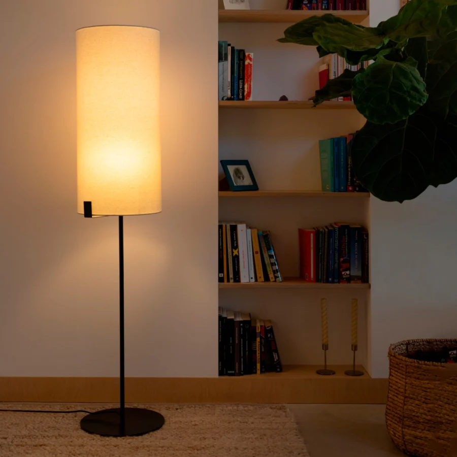 Floor lamp by Faro Barcelona with metal stem in matte black finish and cylindrical off-white fabric shade for soft light