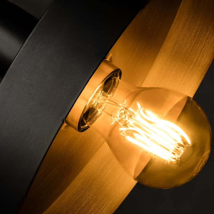 Pendant lamp by Faro Barcelona in metal with matte black exterior and brushed gold interior housing filament light bulb