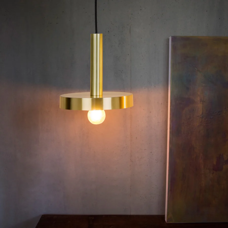 Pendant lamp by Faro Barcelona Whizz in satin gold metal with a cylindrical stem, circular disc and black fabric cord