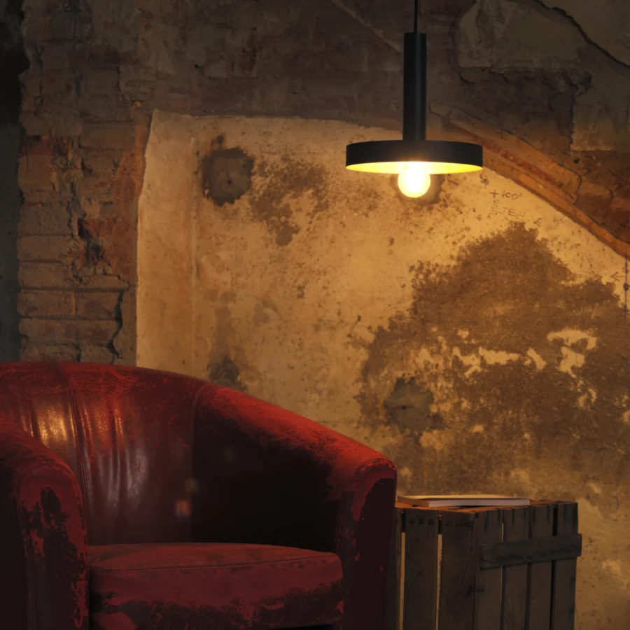 Pendant lamp by Faro Barcelona Whizz in metal with matte black exterior, brass interior, cylindrical stem and disc shade