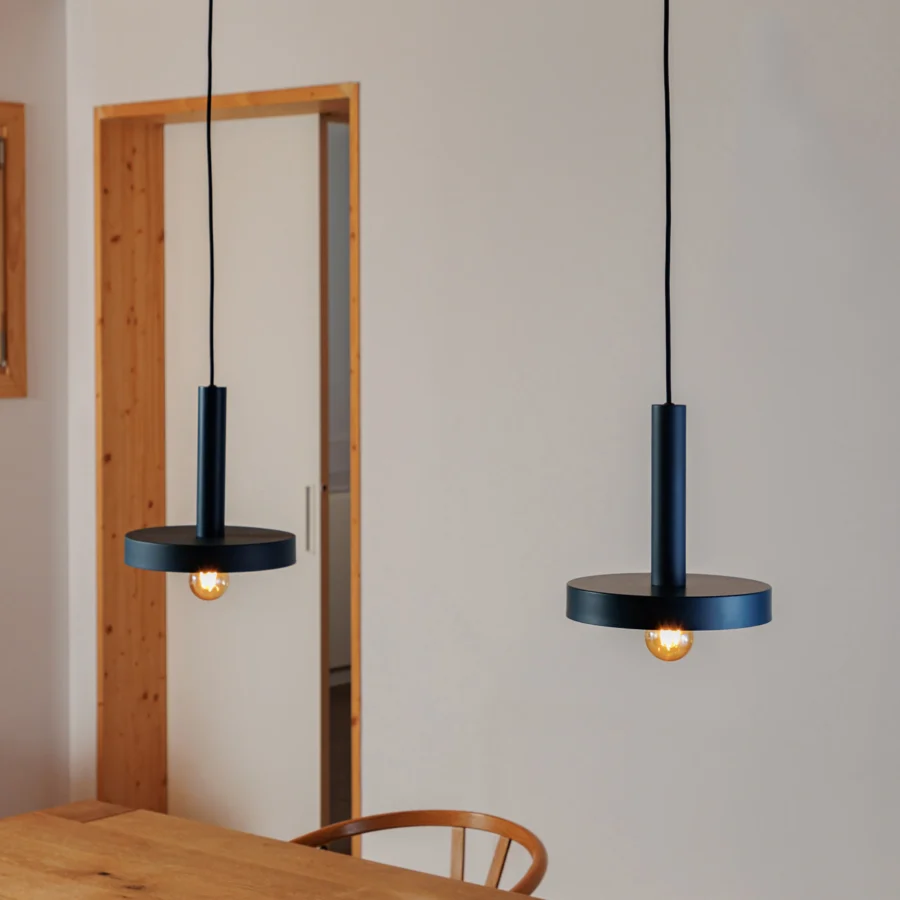 Suspension lamp by Faro Barcelona in black metal with matte finish crafted as a cylindrical stem and flat circular disc