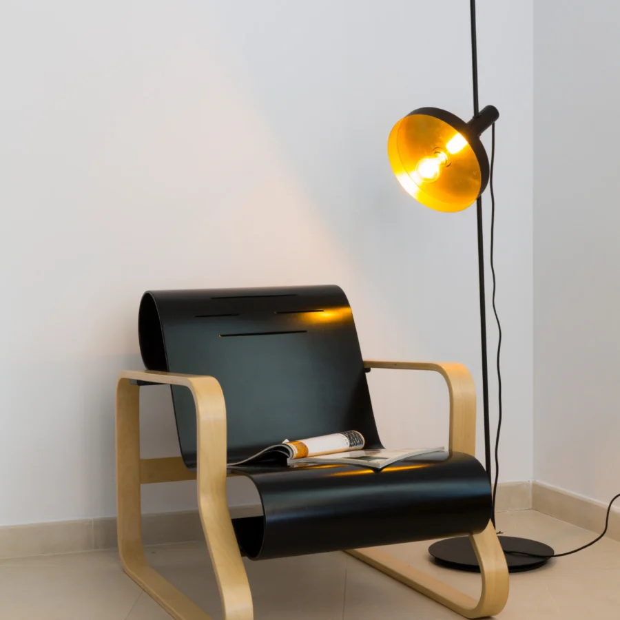 Floor lamp by Faro Barcelona in metal with matte black finish and gold toned interior including adjustable shade stem base