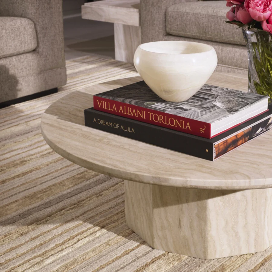 Coffee table by Eichholtz Florence in beige cream travertine with honed finish, faceted hexagonal base, organic grain