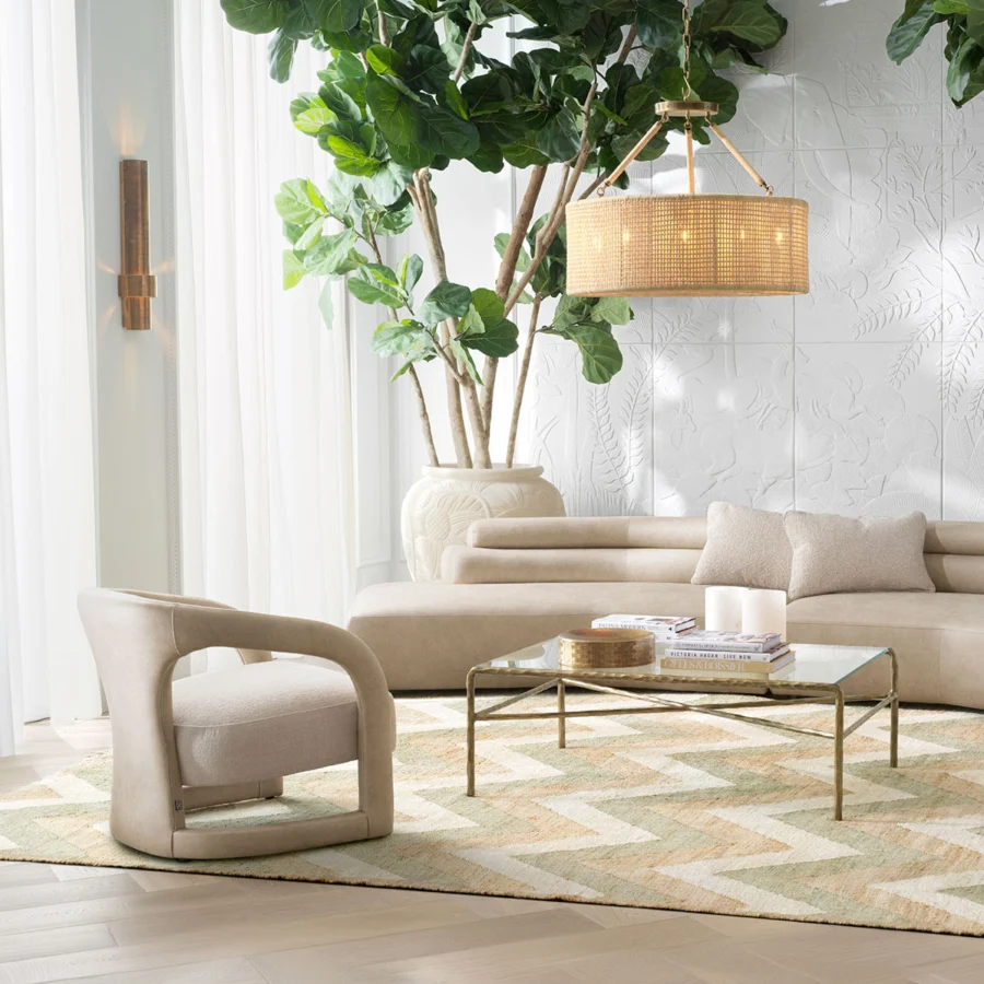 Lounge chair by Eichholtz in Renato ecru fabric featuring a semi circular silhouette on wraparound sled base