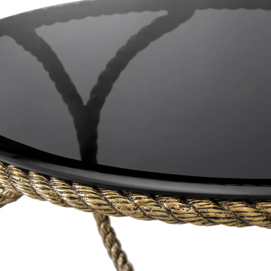 Coffee table by Eichholtz Vedra in smoked glass with a sculptural metal base in a vintage brass rope textured finish